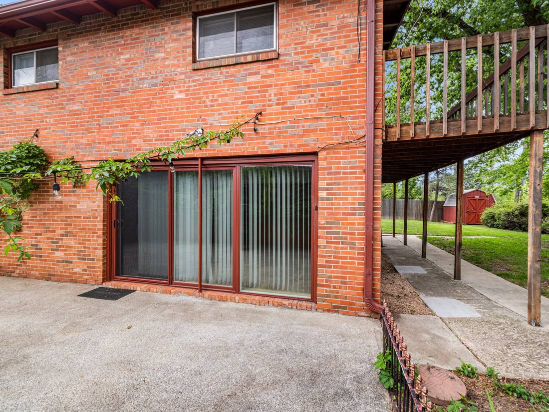 Brick rear elevation with a covered patio and deck above
