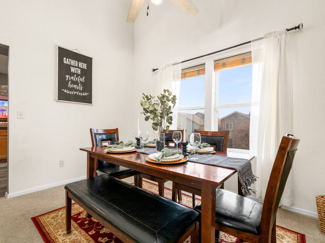 Dining room beneath a two-story window wall