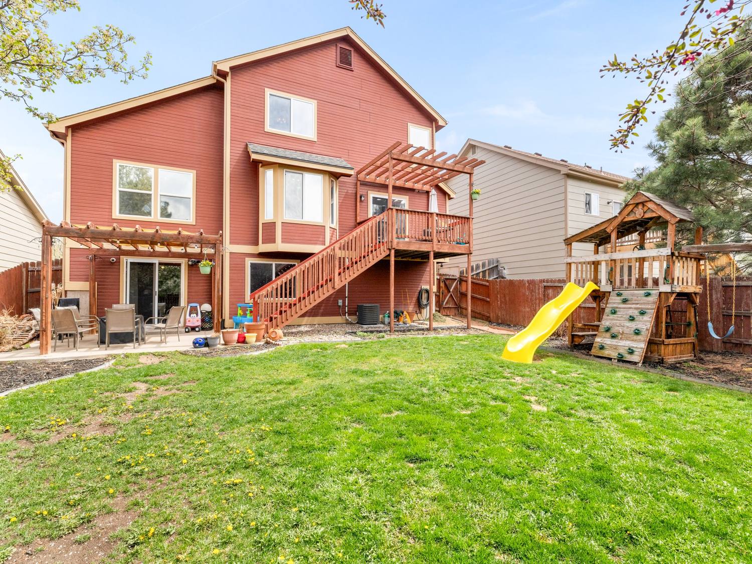 Rear elevation with pergolas, deck and a fenced back yard
