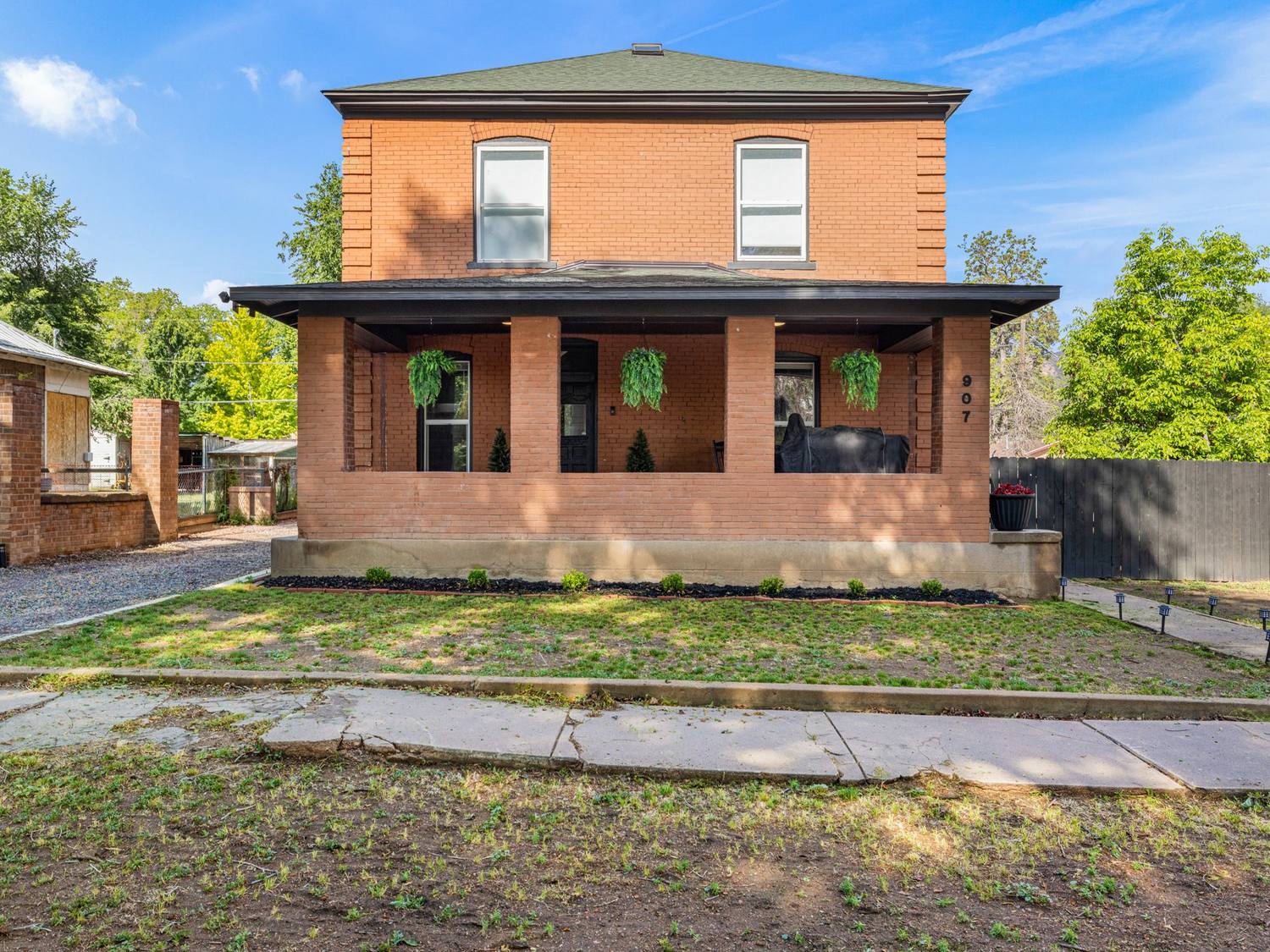 Historic brick two-story with a columned front porch in Ca&ntilde;on City
