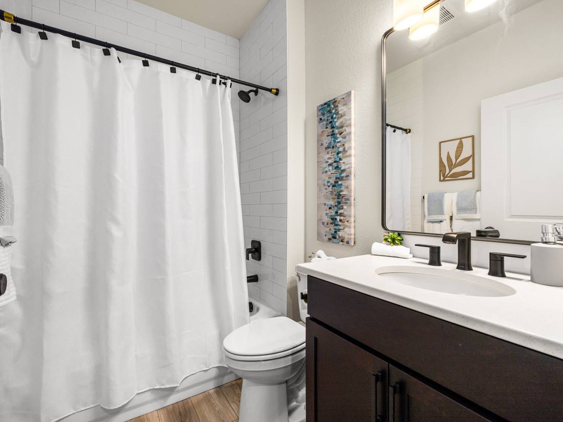 Full bath with subway tile and a quartz vanity