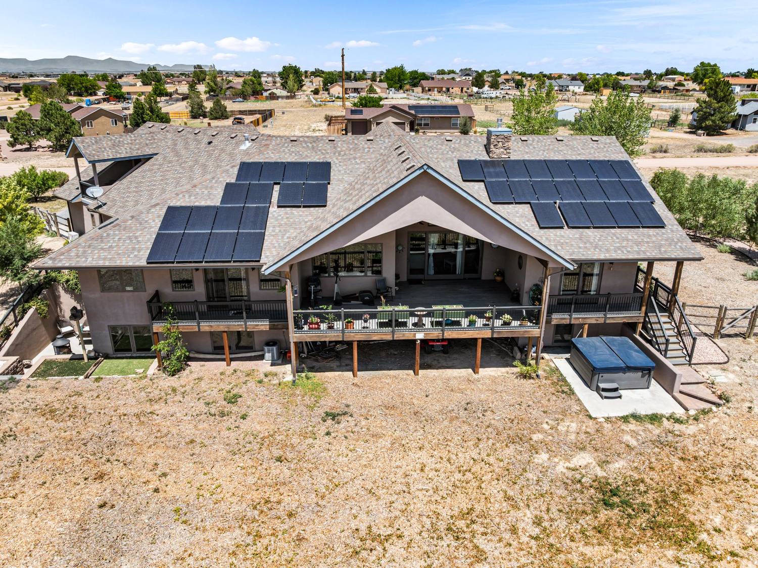 Aerial view of a Pueblo West home, deck and solar array