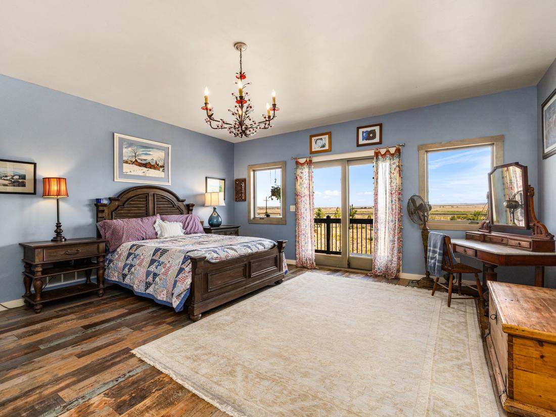 Primary bedroom with doors opening onto the plains
